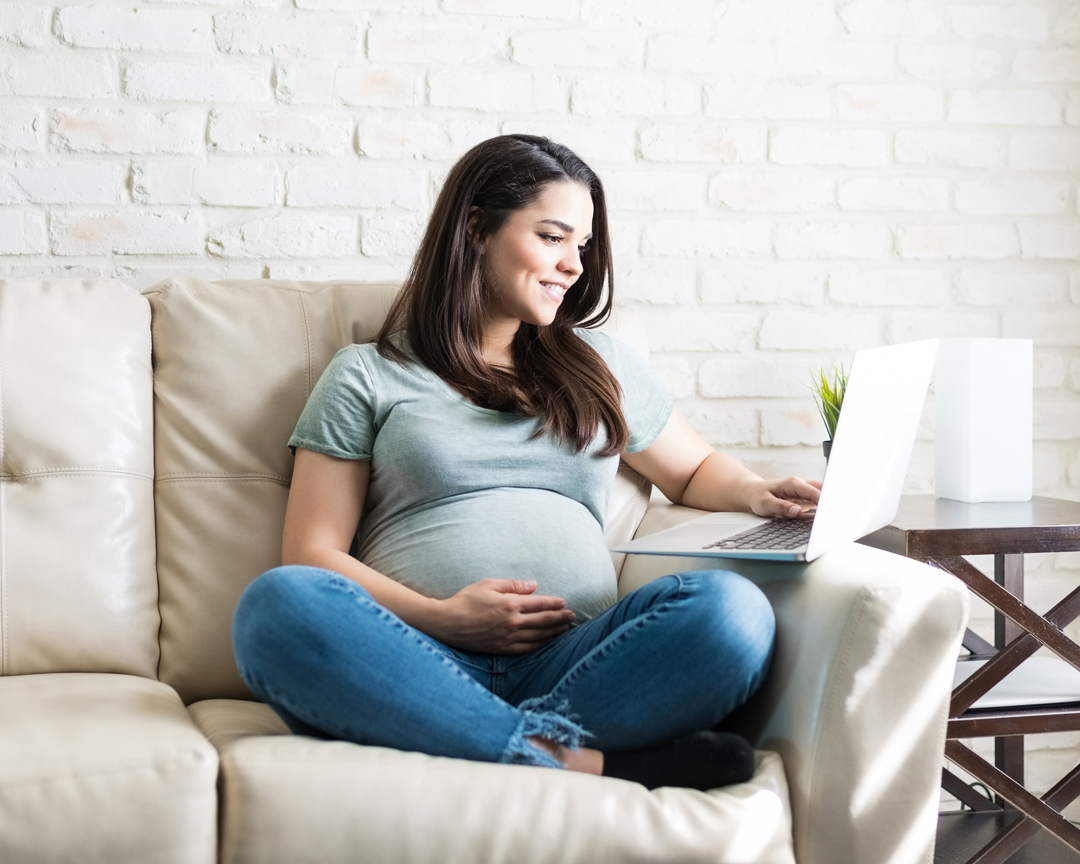 Pregnant woman using laptop.